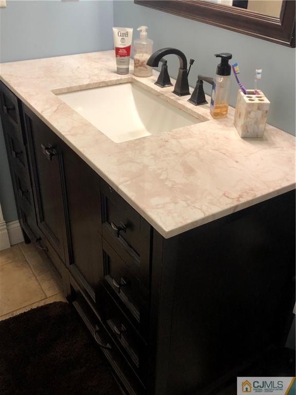 13 Phillips Road Edison, NJ 08817 - Photo 15 of 25 a bathroom with a sink and a mirror