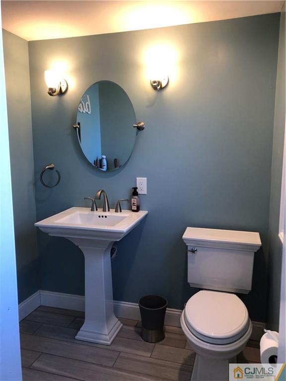 13 Phillips Road Edison, NJ 08817 - Photo 17 of 25 a bathroom with a toilet a sink and mirror