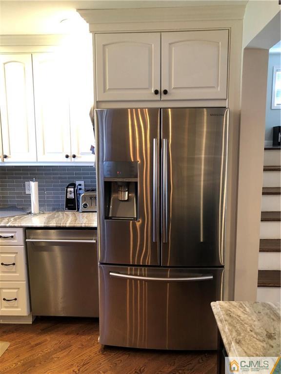 13 Phillips Road Edison, NJ 08817 - Photo 20 of 25 a kitchen with metallic refrigerator and window