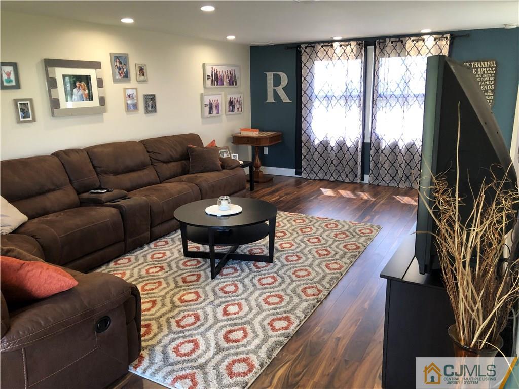 13 Phillips Road Edison, NJ 08817 - Photo 4 of 25 a living room with furniture a flat screen tv and a large window