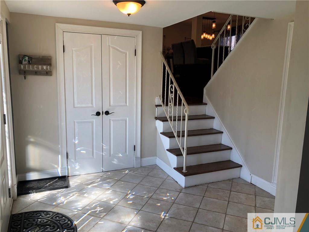 13 Phillips Road Edison, NJ 08817 - Photo 6 of 25 a view of entryway with wooden floor and stairs