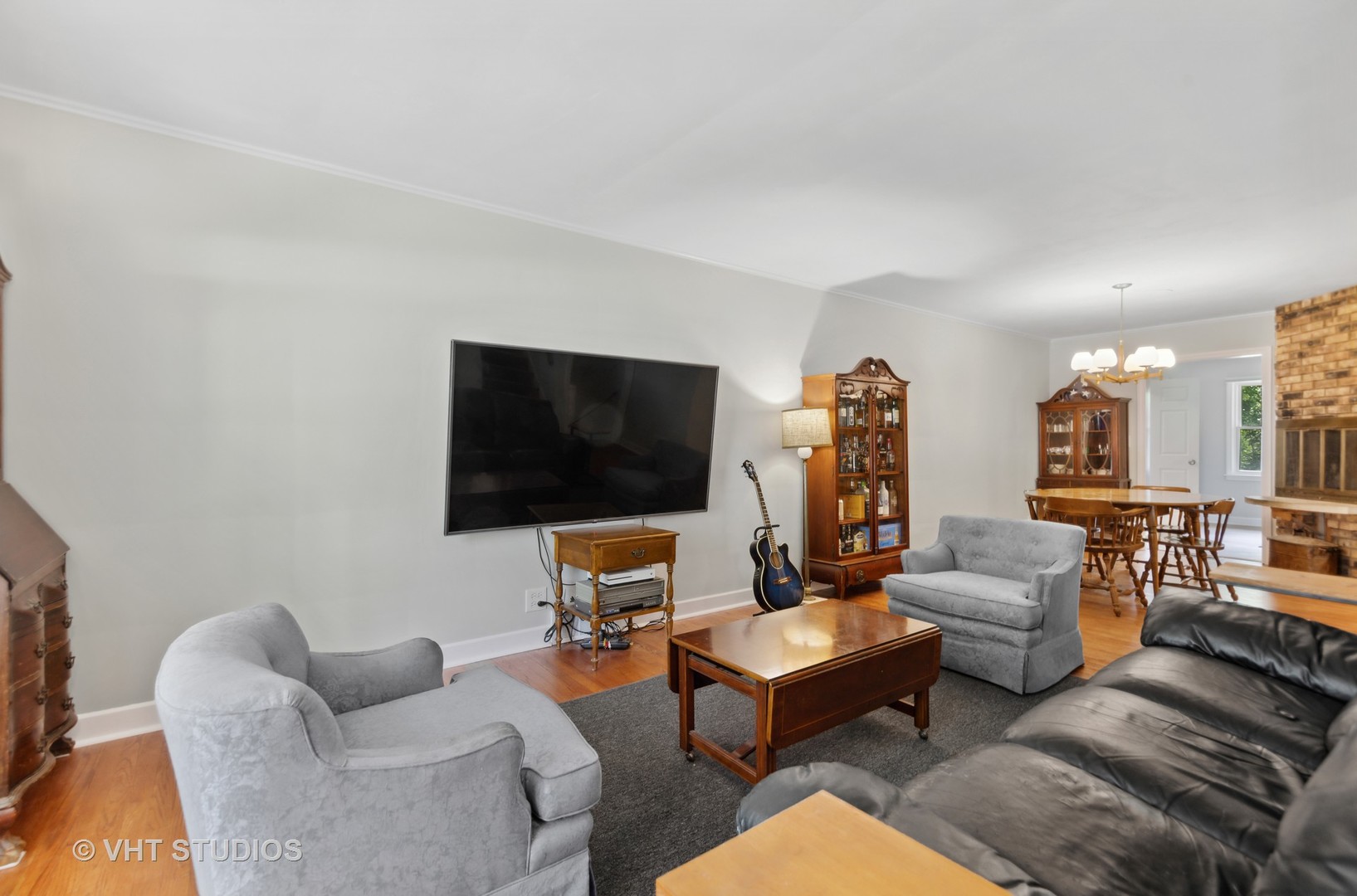831 Warrenville Road Wheaton, IL 60189 - Photo 3 of 26 a living room with furniture and a flat screen tv