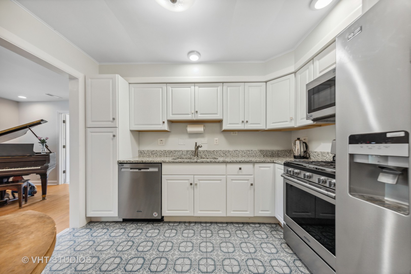 831 Warrenville Road Wheaton, IL 60189 - Photo 6 of 26 a kitchen with granite countertop a stove sink and cabinets