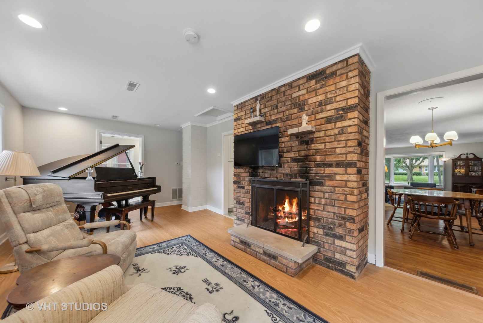 831 Warrenville Road Wheaton, IL 60189 - Photo 8 of 26 a living room with furniture a flat screen tv and a fireplace
