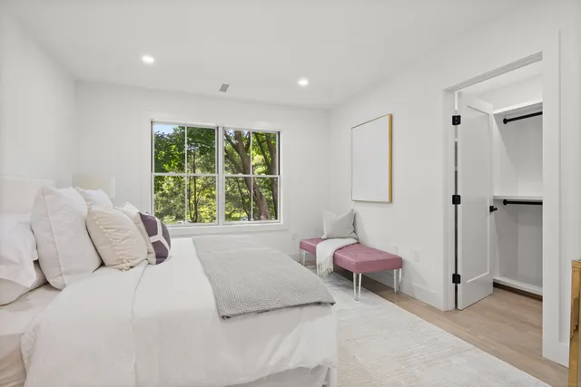 a spacious bathroom with a mirror a double vanity sink and shower