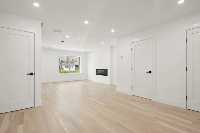 an empty room with windows and closet