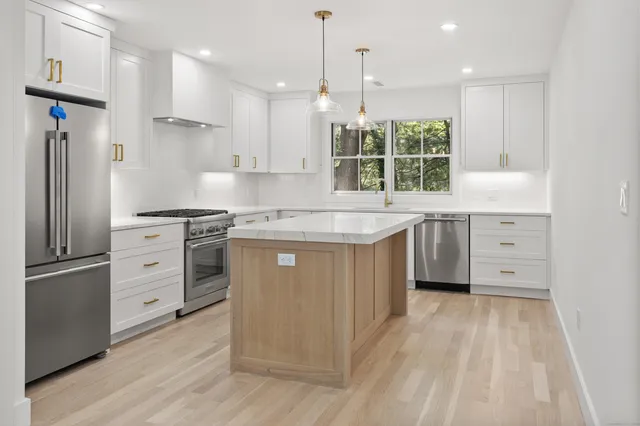 a bathroom with a shower sink and mirror