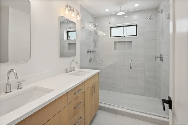 a bathroom with a sink a toilet and shower