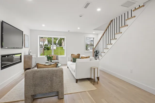 a living room with fireplace furniture and a flat screen tv