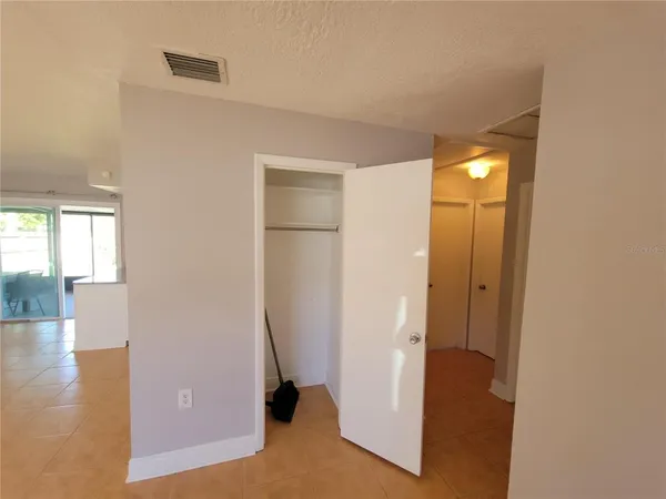 a view of a room with wooden floor and windows