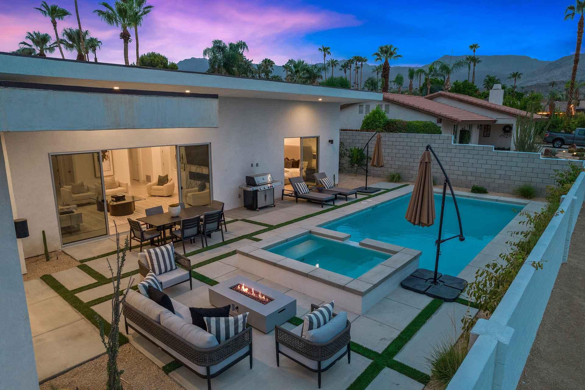 72985 Somera Road Palm Desert, CA 92260 - Photo 15 of 17 a view of a patio with couches table and chairs with wooden floor and fence