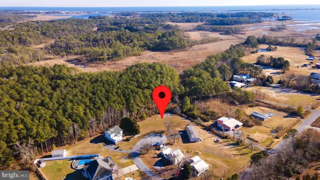 an aerial view of a houses with a swimming pool
