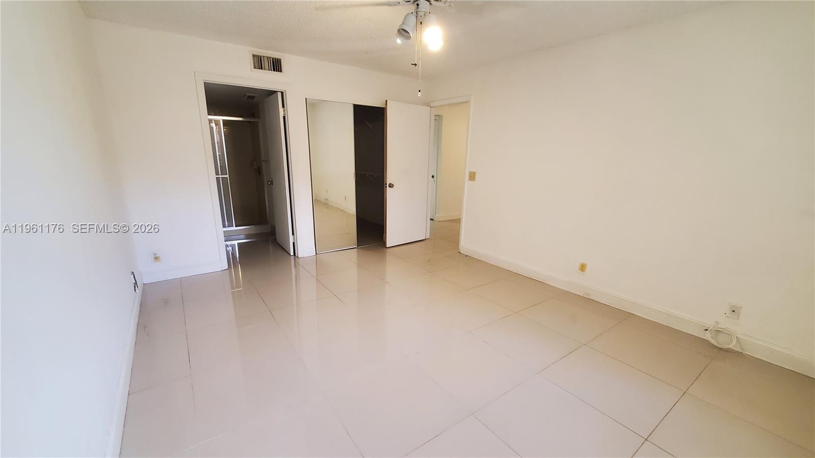 9055 Wiles Road, Unit 103 Coral Springs, FL 33067 - Photo 15 of 19 an empty room with closet and a hallway