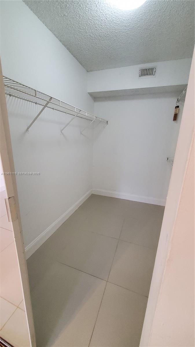 9055 Wiles Road, Unit 103 Coral Springs, FL 33067 - Photo 16 of 19 a view of a room with racks on the wall