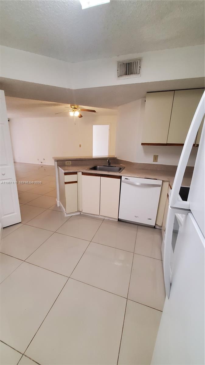 9055 Wiles Road, Unit 103 Coral Springs, FL 33067 - Photo 10 of 19 a kitchen with stainless steel appliances a sink and a stove