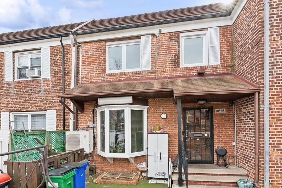 front view of a brick house with a large windows