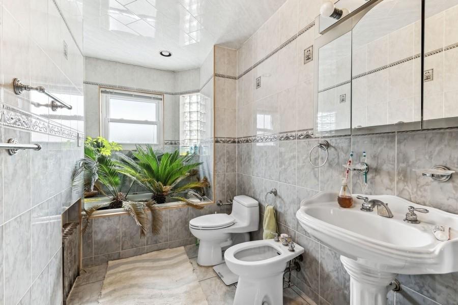 108-28 65th Road Queens, NY 11375 - Photo 11 of 15 a bathroom with a sink a toilet and a shower