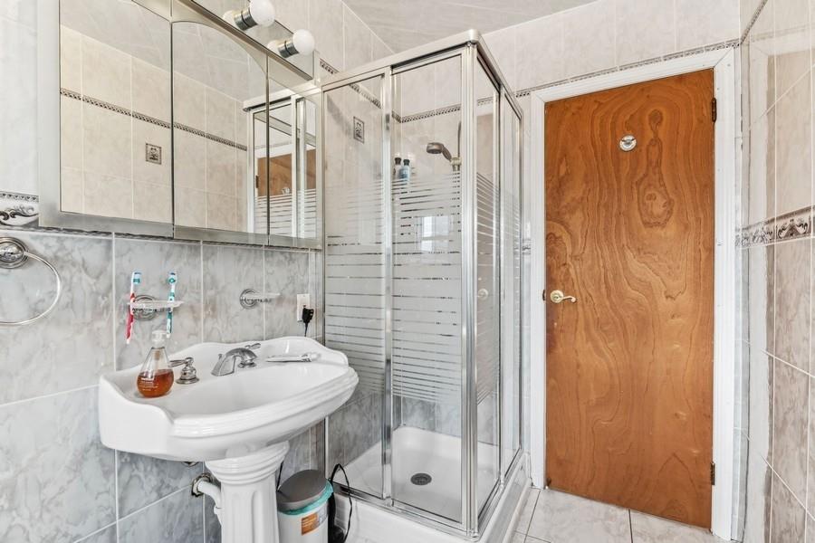 108-28 65th Road Queens, NY 11375 - Photo 12 of 15 a bathroom with a sink shower and a mirror