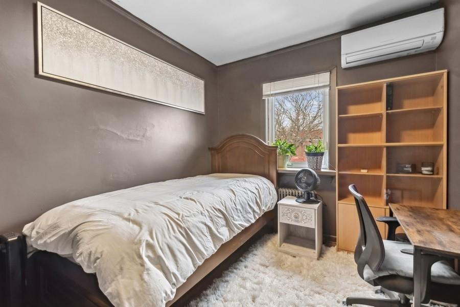 108-28 65th Road Queens, NY 11375 - Photo 13 of 15 a bed sitting in a bedroom next to a window