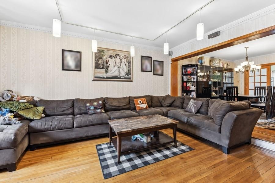 108-28 65th Road Queens, NY 11375 - Photo 2 of 15 a living room with furniture a rug and a large window