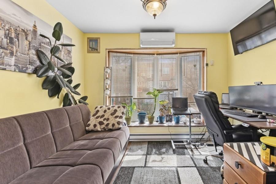 108-28 65th Road Queens, NY 11375 - Photo 5 of 15 a living room with furniture and a flat screen tv