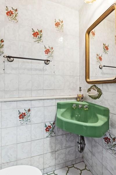 108-28 65th Road Queens, NY 11375 - Photo 8 of 15 a bathroom with a sink and a mirror