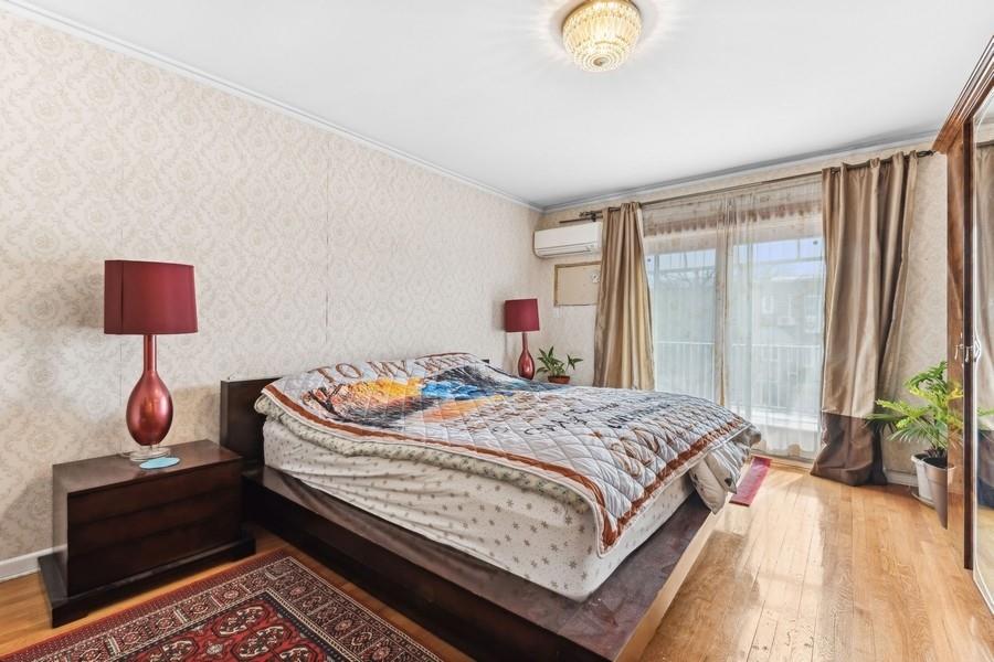 108-28 65th Road Queens, NY 11375 - Photo 9 of 15 a bedroom with a bed and window