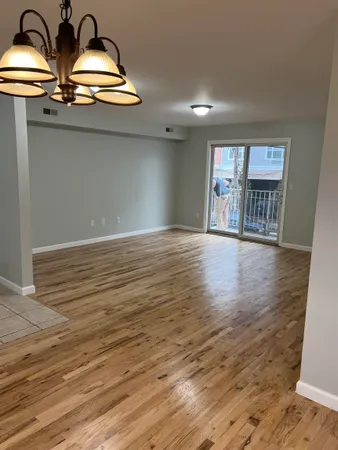 a view of room with wooden floor