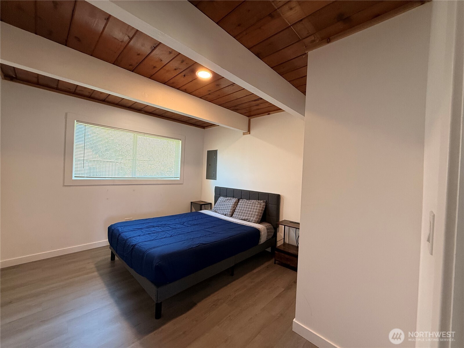 141 Barnacle Street Ocean Shores, WA 98569 - Photo 15 of 27 a bed sitting in a bedroom next to a window