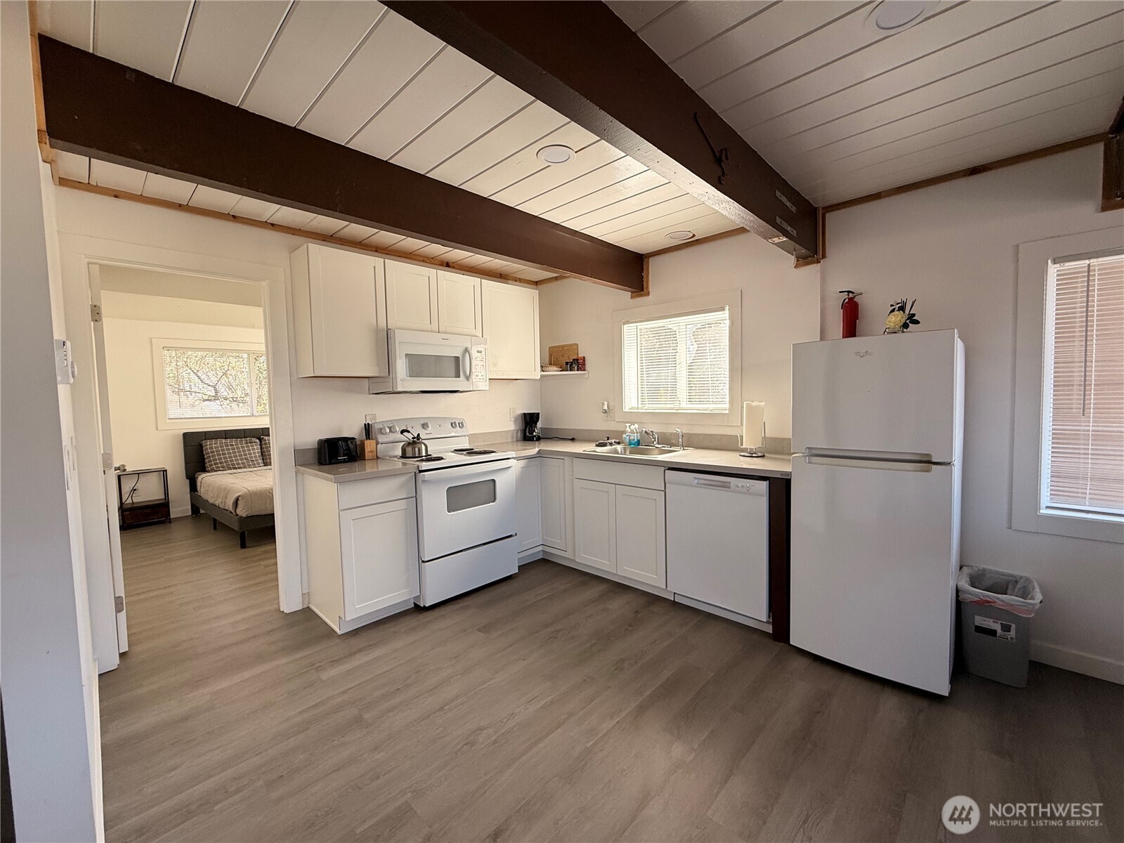 141 Barnacle Street Ocean Shores, WA 98569 - Photo 3 of 27 a kitchen with a refrigerator a sink and cabinets
