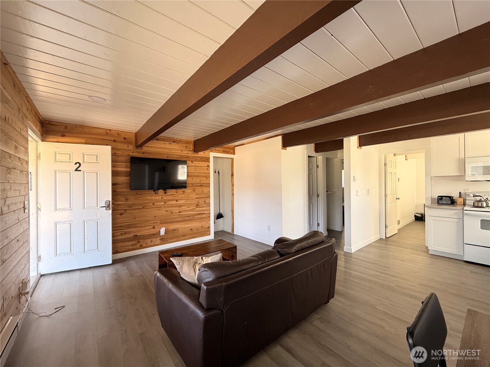 141 Barnacle Street Ocean Shores, WA 98569 - Photo 6 of 27 a living room with furniture and large windows