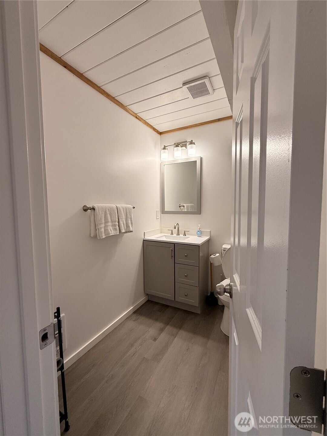 141 Barnacle Street Ocean Shores, WA 98569 - Photo 9 of 27 a bathroom with a double vanity sink toilet and mirror