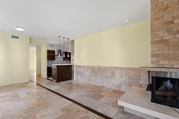 a view of a kitchen with refrigerator and more cabinets