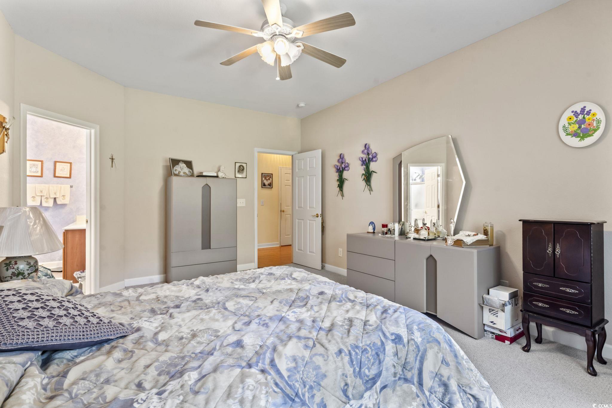 2356 Seneca Ridge Drive Myrtle Beach, SC 29579 - Photo 18 of 39 Bedroom with carpet flooring, ceiling fan, and ensuite bathroom