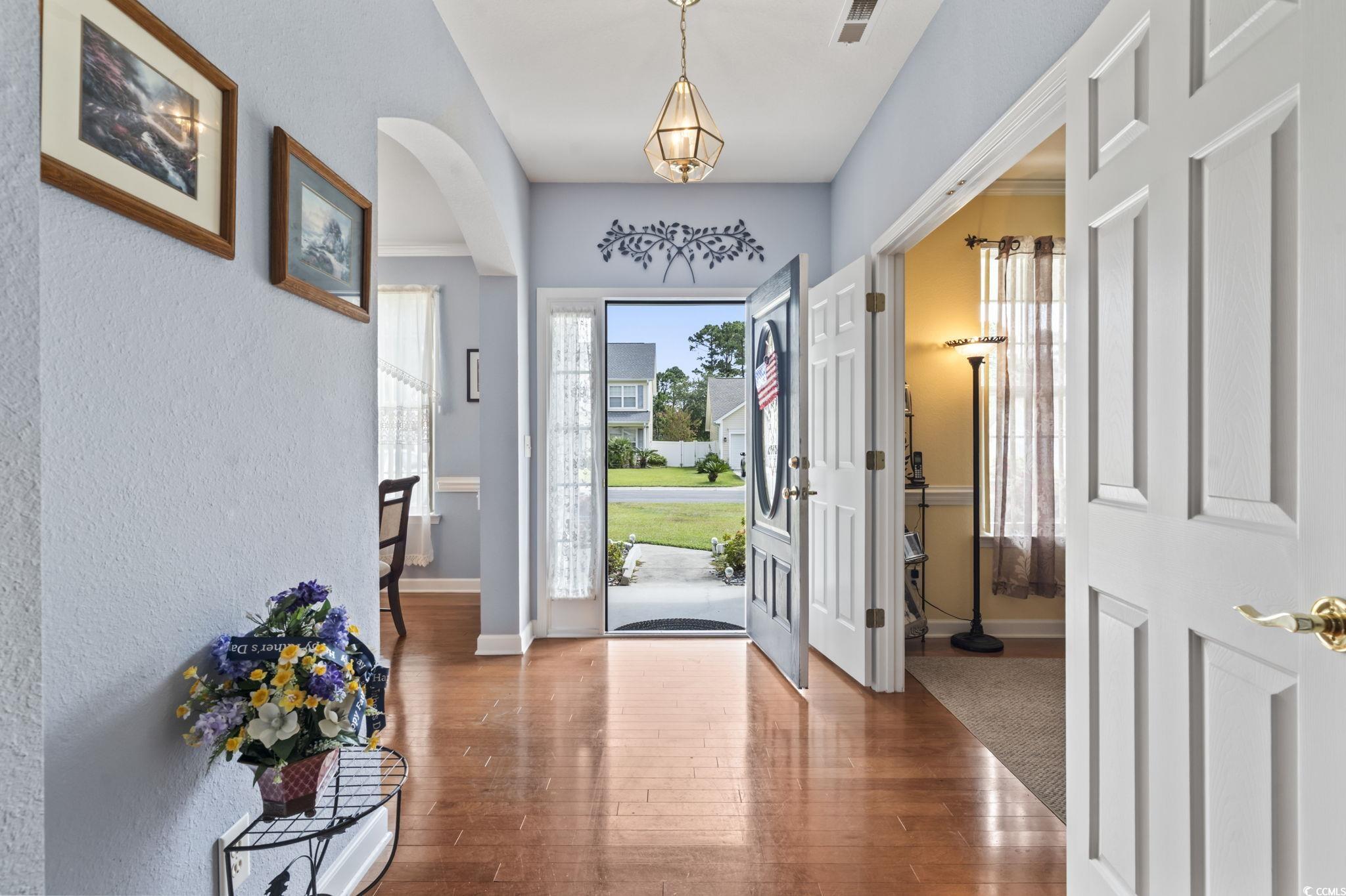 2356 Seneca Ridge Drive Myrtle Beach, SC 29579 - Photo 3 of 39 Foyer featuring arched walkways, hardwood / wood-style floors, and a textured wall
