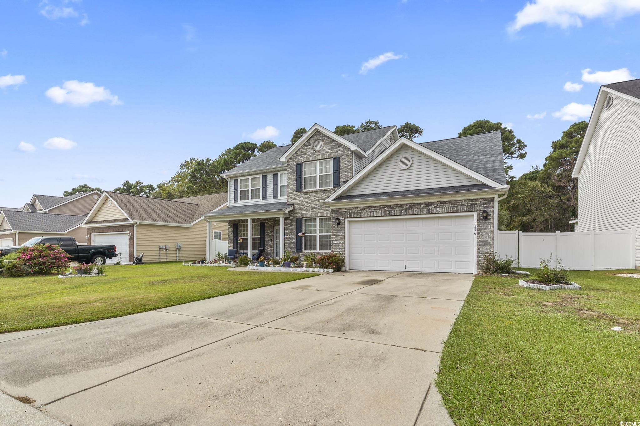 2356 Seneca Ridge Drive Myrtle Beach, SC 29579 - Photo 38 of 39 Traditional home with driveway, stone siding, a porch, and an attached garage