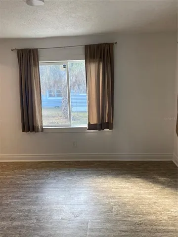 an entryway door with wooden floor