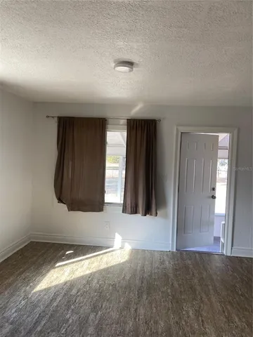 a kitchen with granite countertop white cabinets and sink