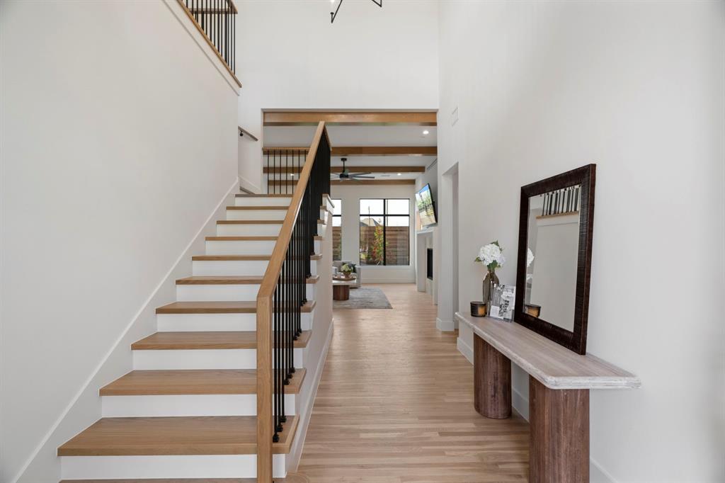 3316 Ferguson Road Grapevine, TX 76092 - Photo 3 of 39 Stairway featuring wood finished floors, a high ceiling, and ceiling fan