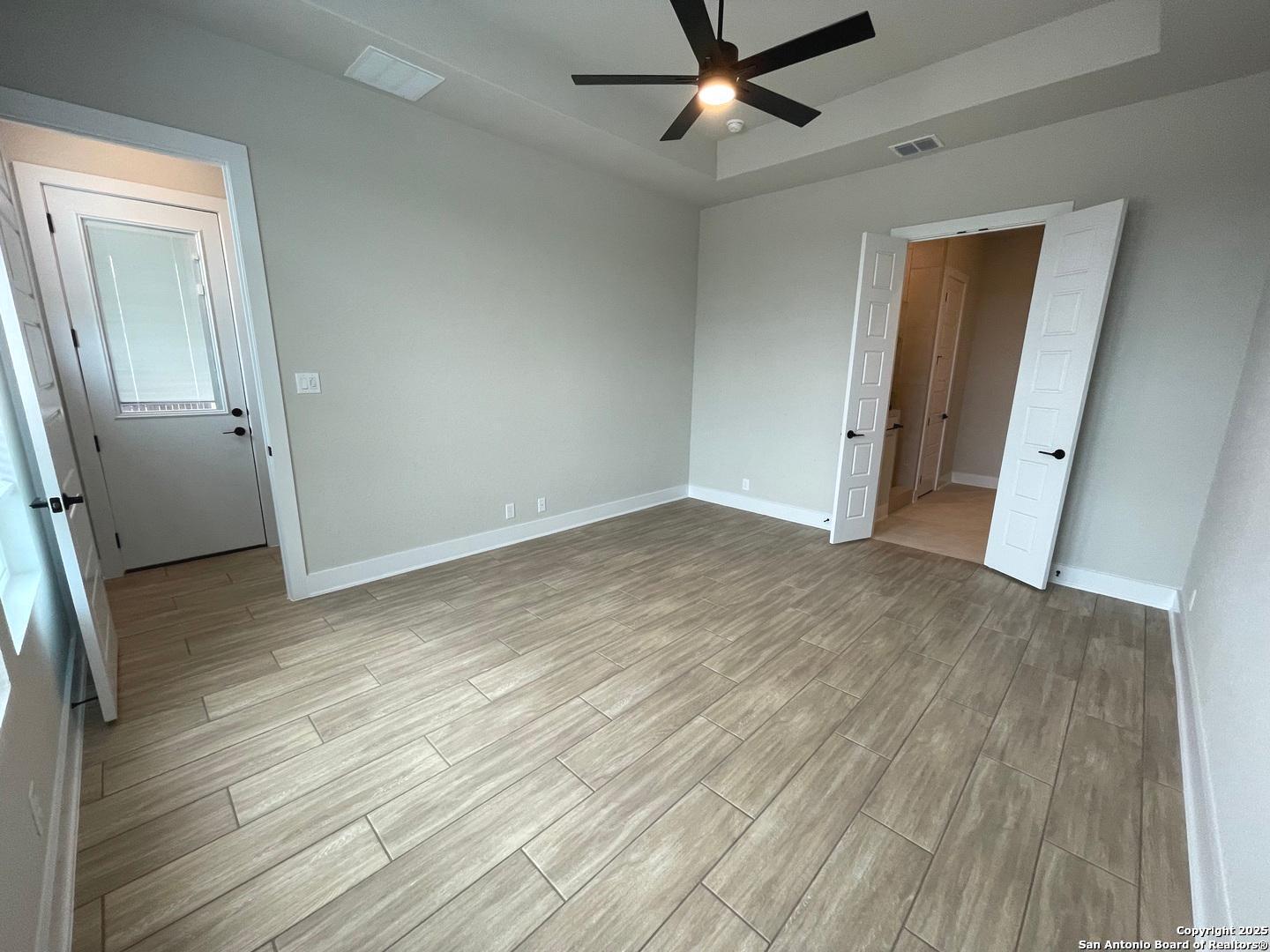 20675 Huebner Road, Unit 525 San Antonio, TX 78258 - Photo 11 of 19 an empty room with wooden floor and closet