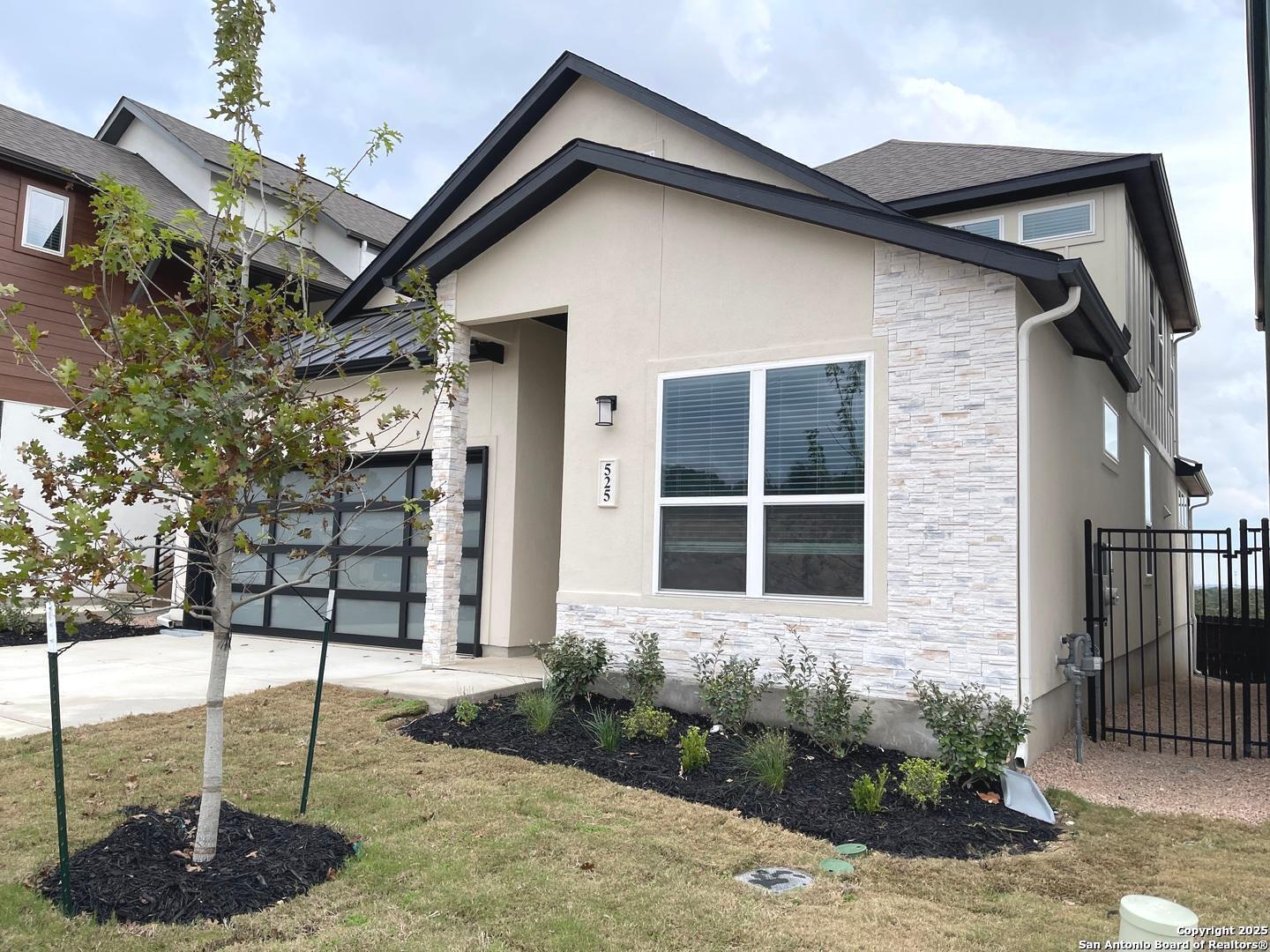 20675 Huebner Road, Unit 525 San Antonio, TX 78258 - Photo 2 of 19 a front view of a house with garden
