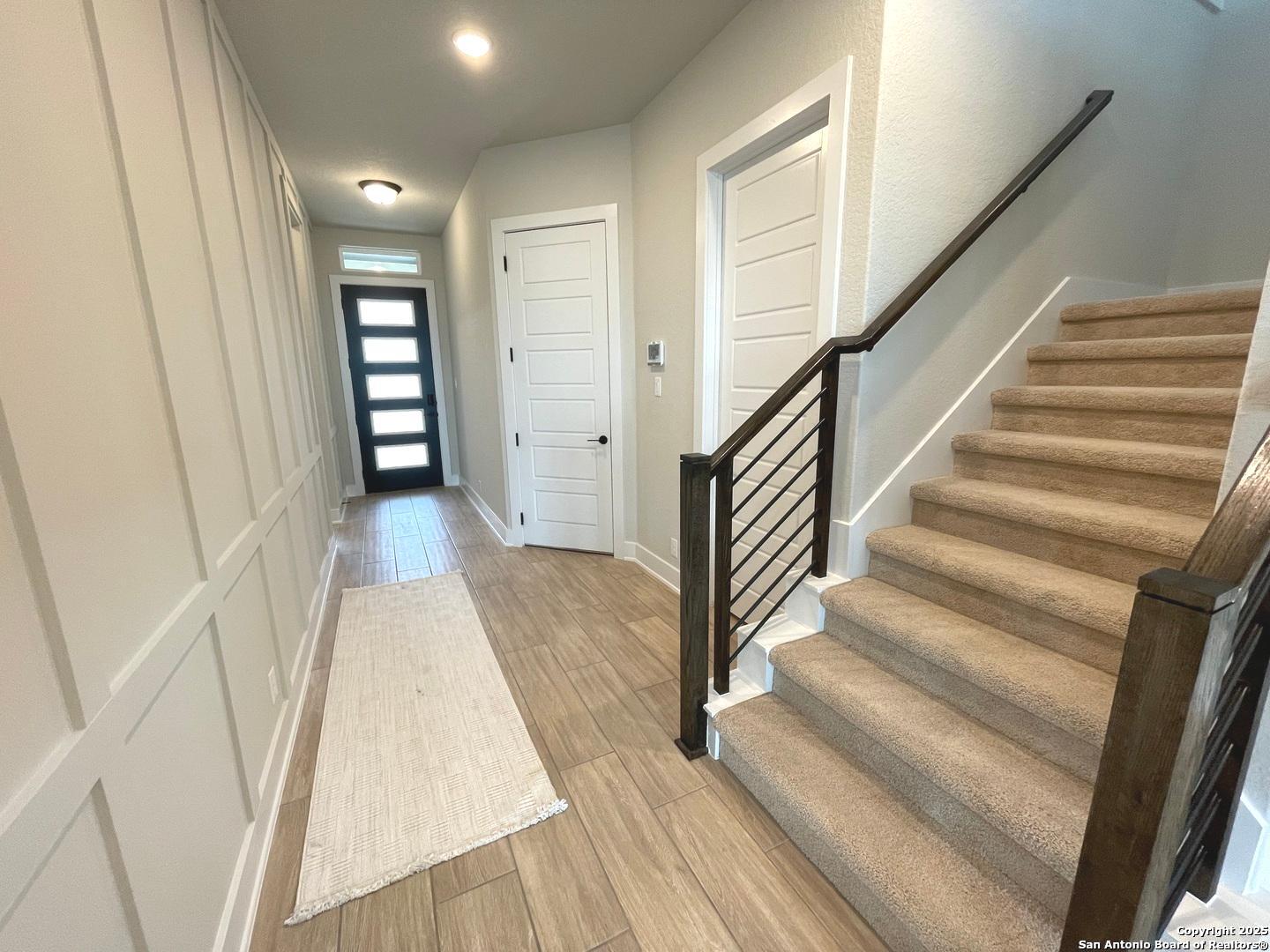 20675 Huebner Road, Unit 525 San Antonio, TX 78258 - Photo 3 of 19 a view of a hallway with wooden floor and entryway