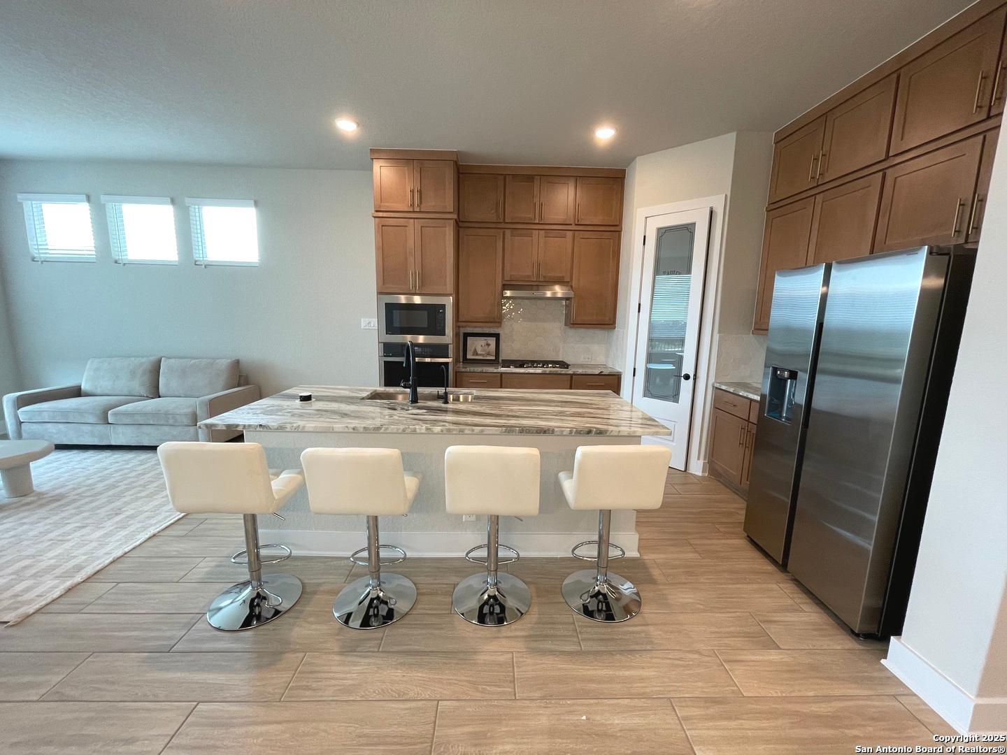 20675 Huebner Road, Unit 525 San Antonio, TX 78258 - Photo 5 of 19 a bathroom with a sink a mirror and a glass door shower