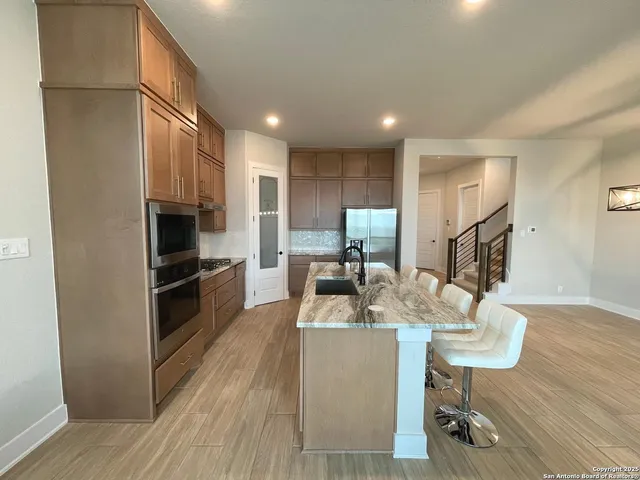 a kitchen with refrigerator and cabinets