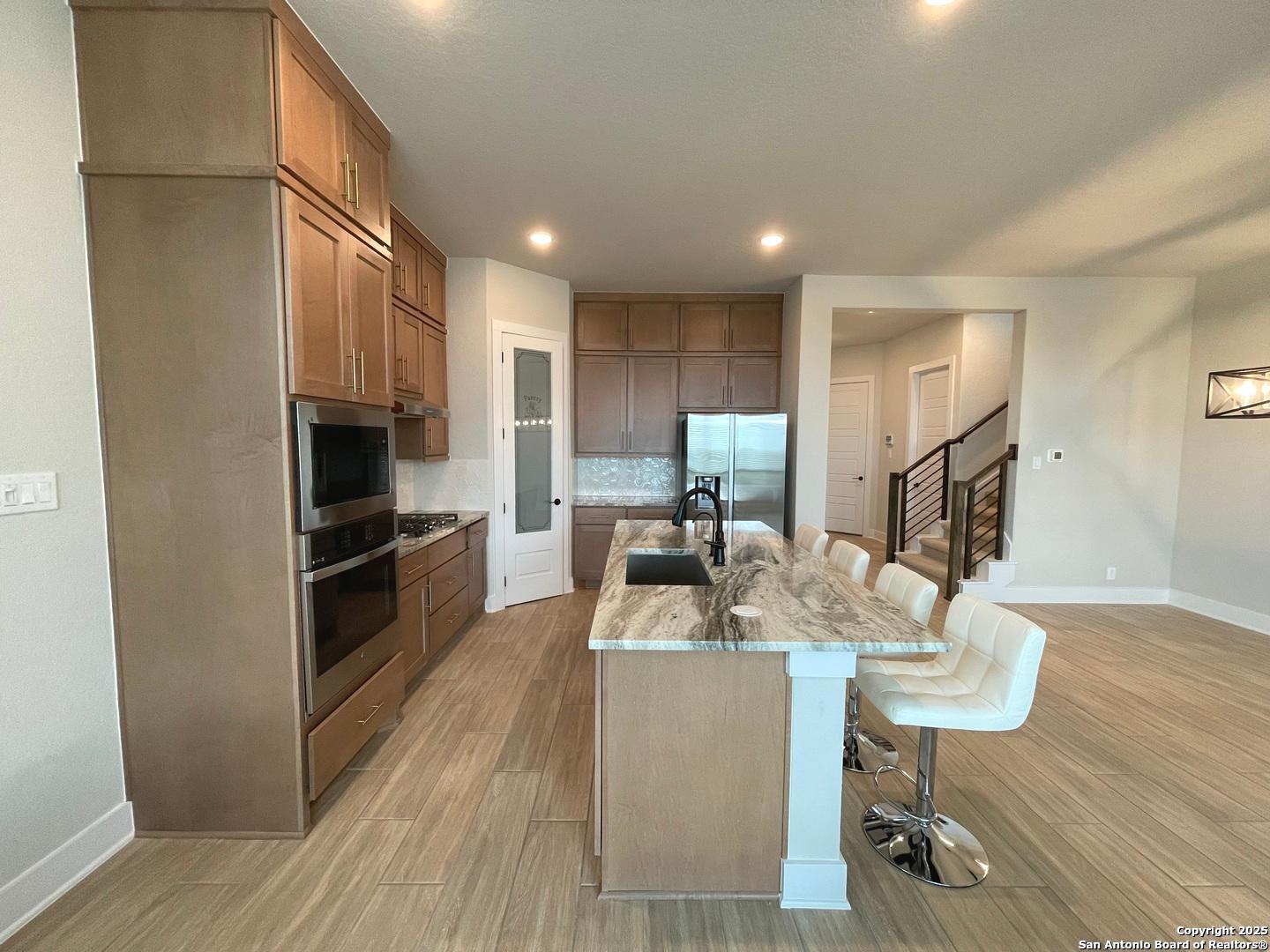 20675 Huebner Road, Unit 525 San Antonio, TX 78258 - Photo 7 of 19 a kitchen with refrigerator and cabinets
