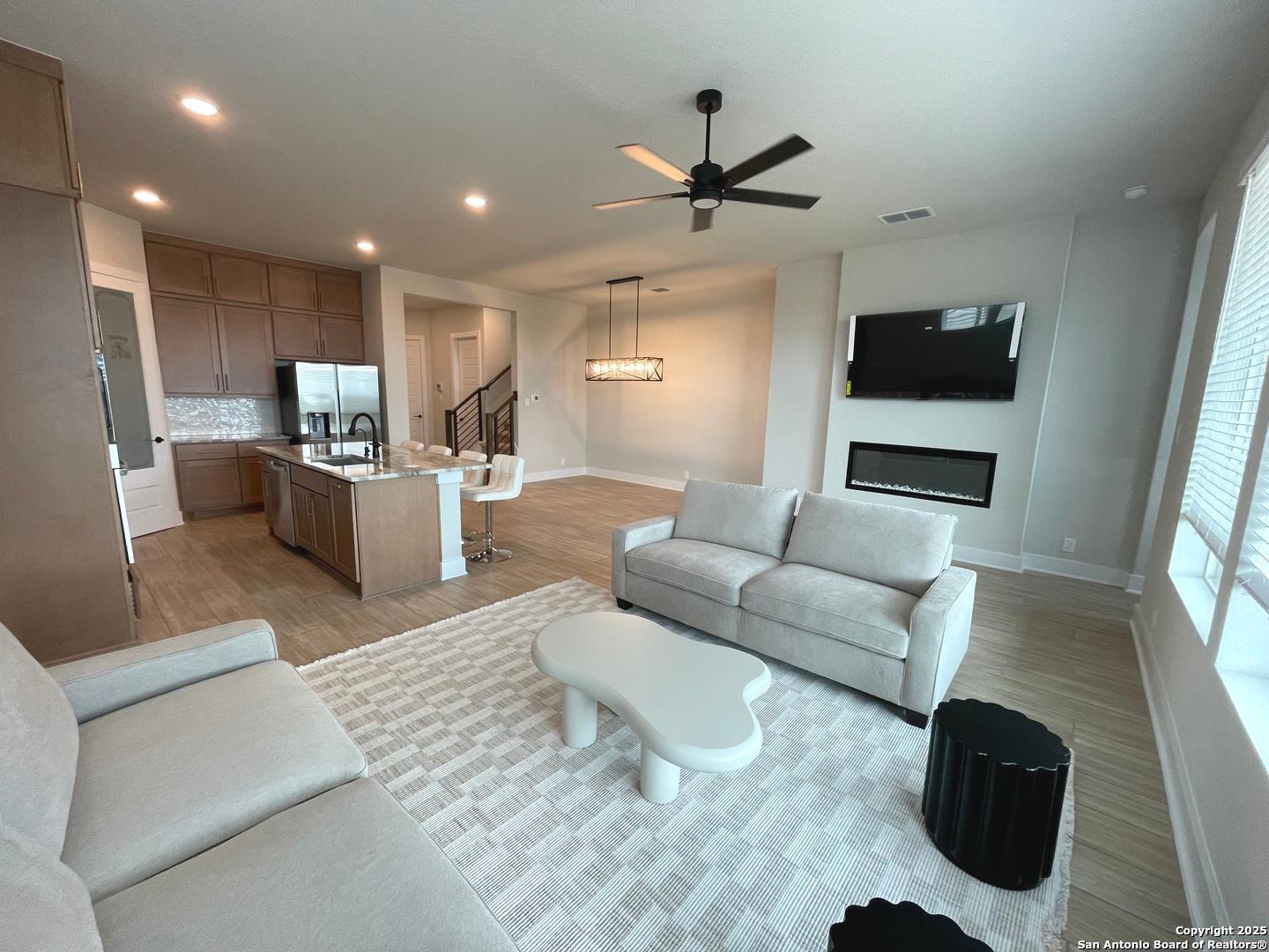 20675 Huebner Road, Unit 525 San Antonio, TX 78258 - Photo 8 of 19 a living room with furniture and a flat screen tv