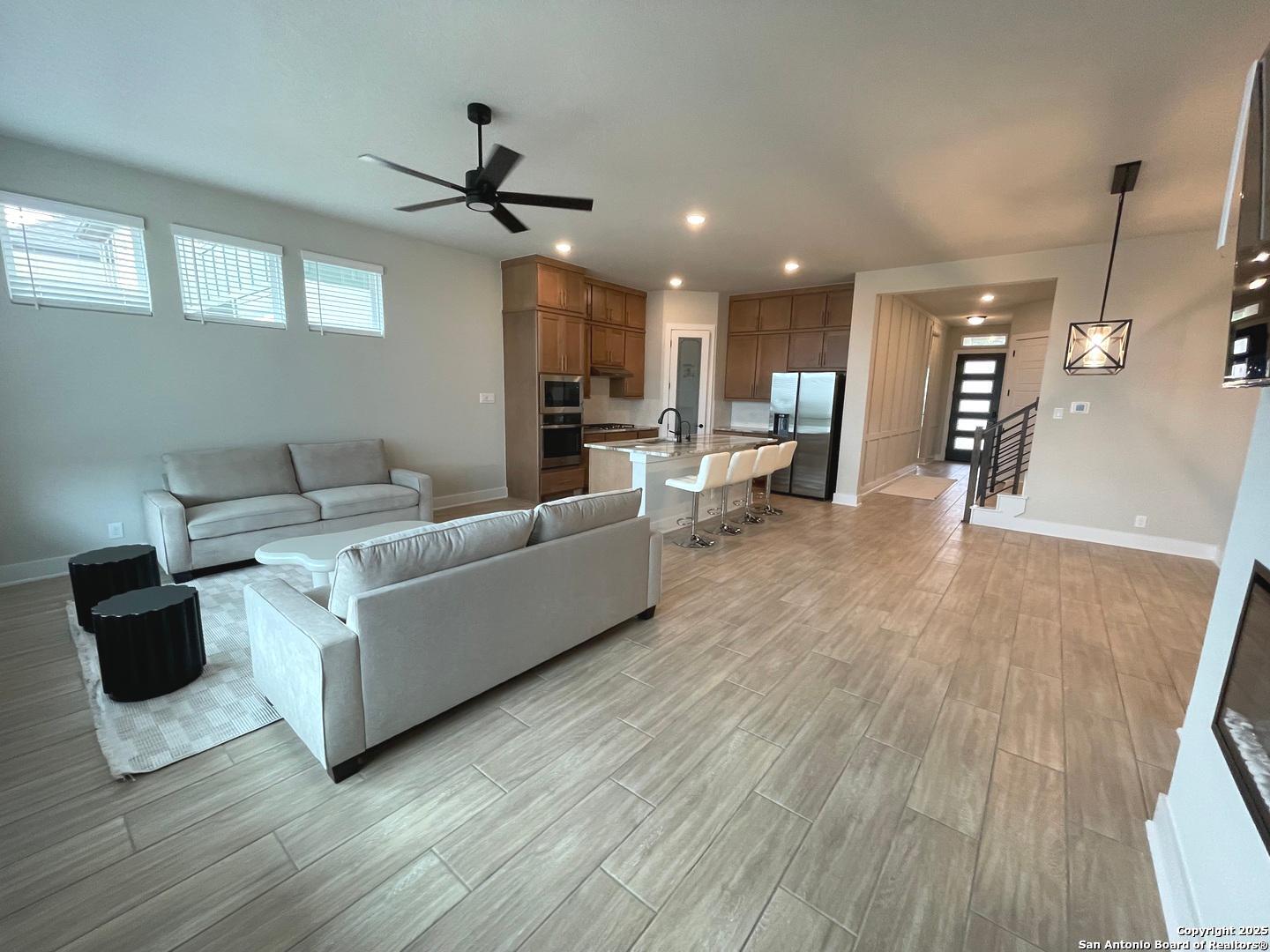 20675 Huebner Road, Unit 525 San Antonio, TX 78258 - Photo 9 of 19 a living room with furniture and a wooden floor
