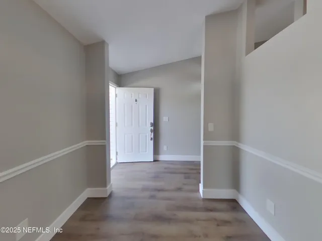 a view of entryway with wooden floor