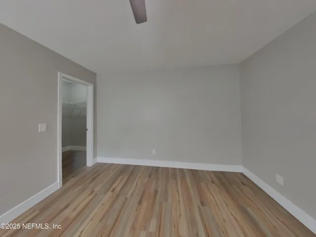 a view of a room with wooden floor