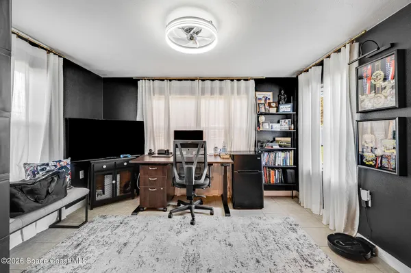 a view of a livingroom with workspace and a window